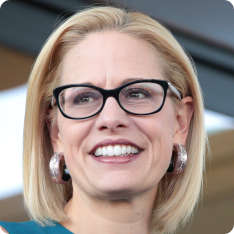 U.S. Congresswoman Kyrsten Sinema speaking with supporters at a neighborhood...